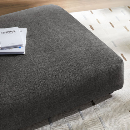 Solace modular upholstered fabric ottoman in dark gray with a magazine stack on Tampa Home & Garden Store