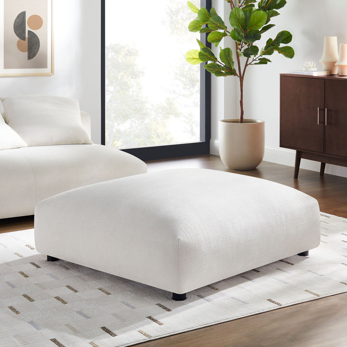 Solace modular upholstered fabric ottomans in cream, pair in a modern living room with plant on Tampa Home & Garden Store