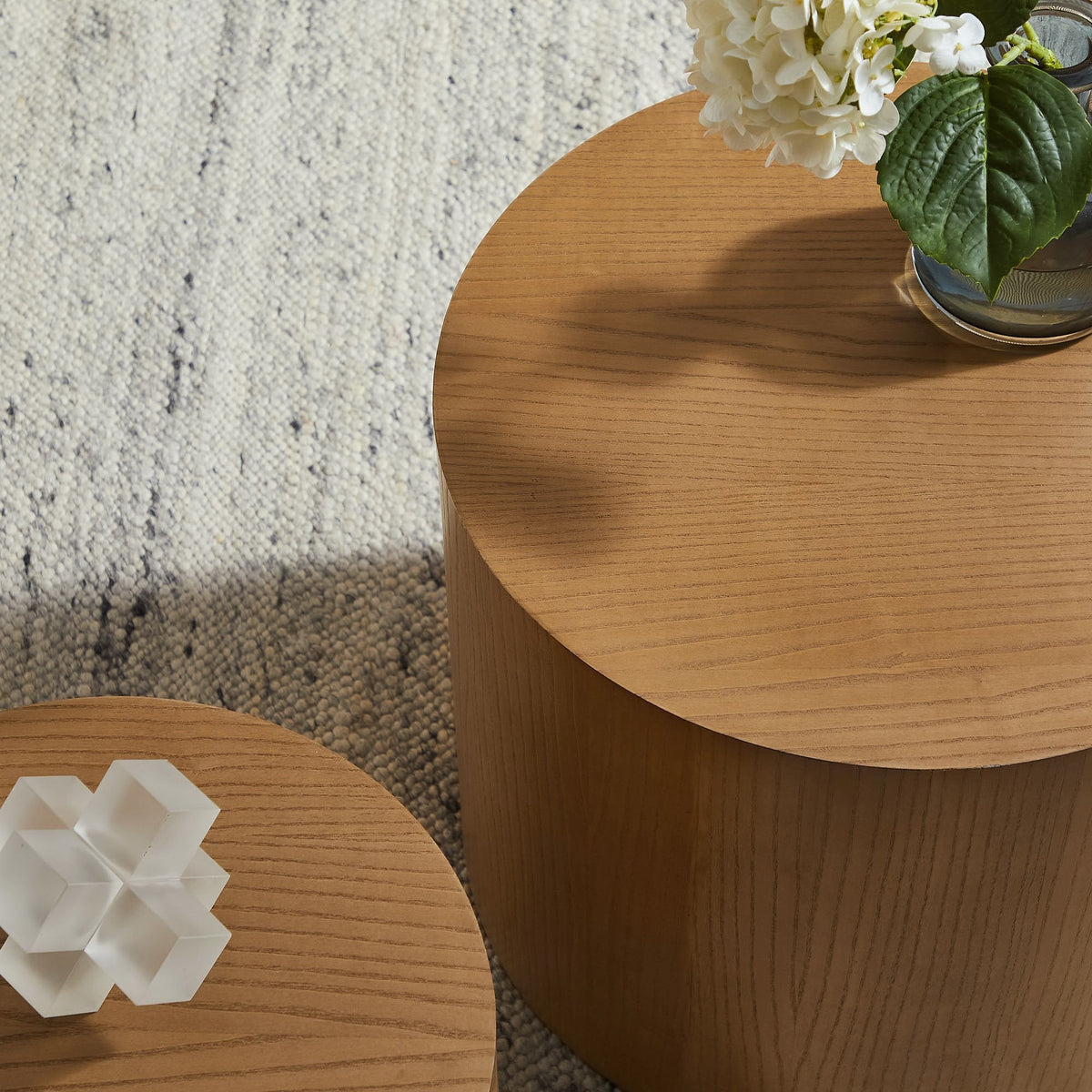 Amani round nesting coffee tables set of 2 in oak finish with white vase on wood surface on Tampa Home & Garden Store