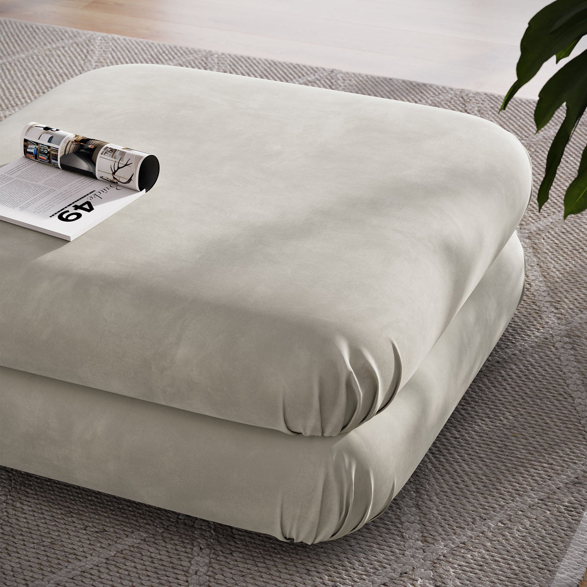 Jubilee Modular Performance Velvet Ottoman cream on beige rug with rolled magazine HouseOfZazla on Tampa Home & Garden Store