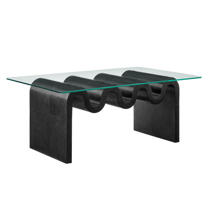Ondine glass top coffee table with black sculptural base featuring curved roller-like legs on Tampa Home & Garden Store