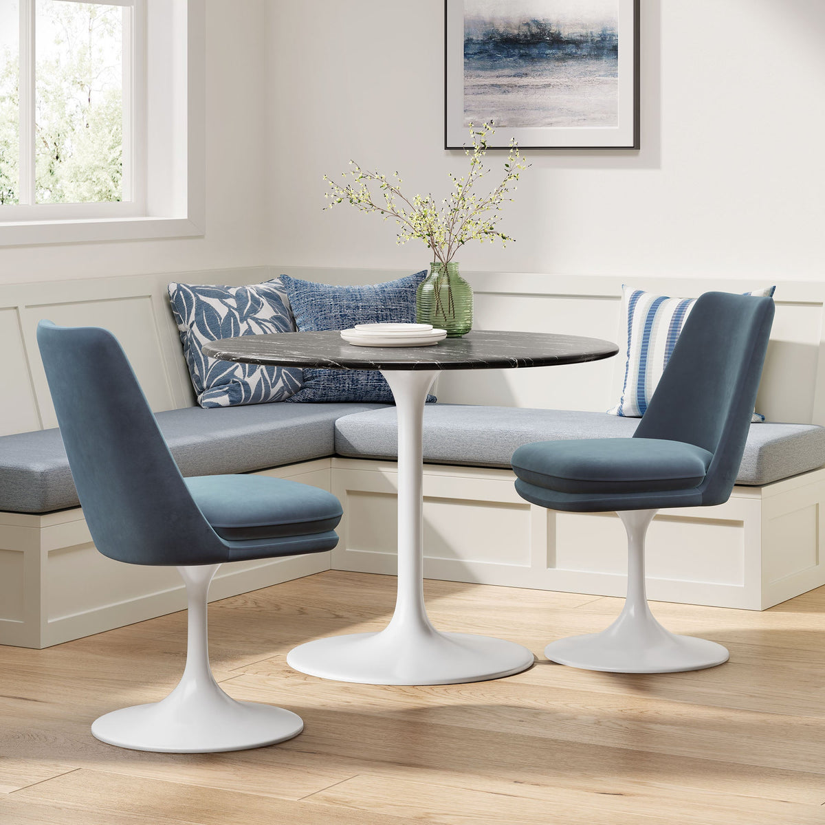 Two blue Lippa Swivel Dining Performance Velvet Side Chairs around a marble round table on Tampa Home & Garden Store