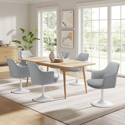 Lippa Swivel Dining Armchairs in gray fabric with white tulip bases around a six-seat table on Tampa Home & Garden Store