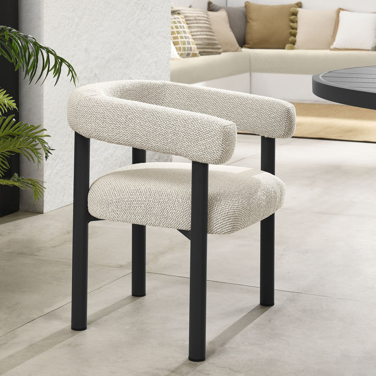 Two beige upholstered dining armchairs with black legs in a modern living space on Tampa Home & Garden Store