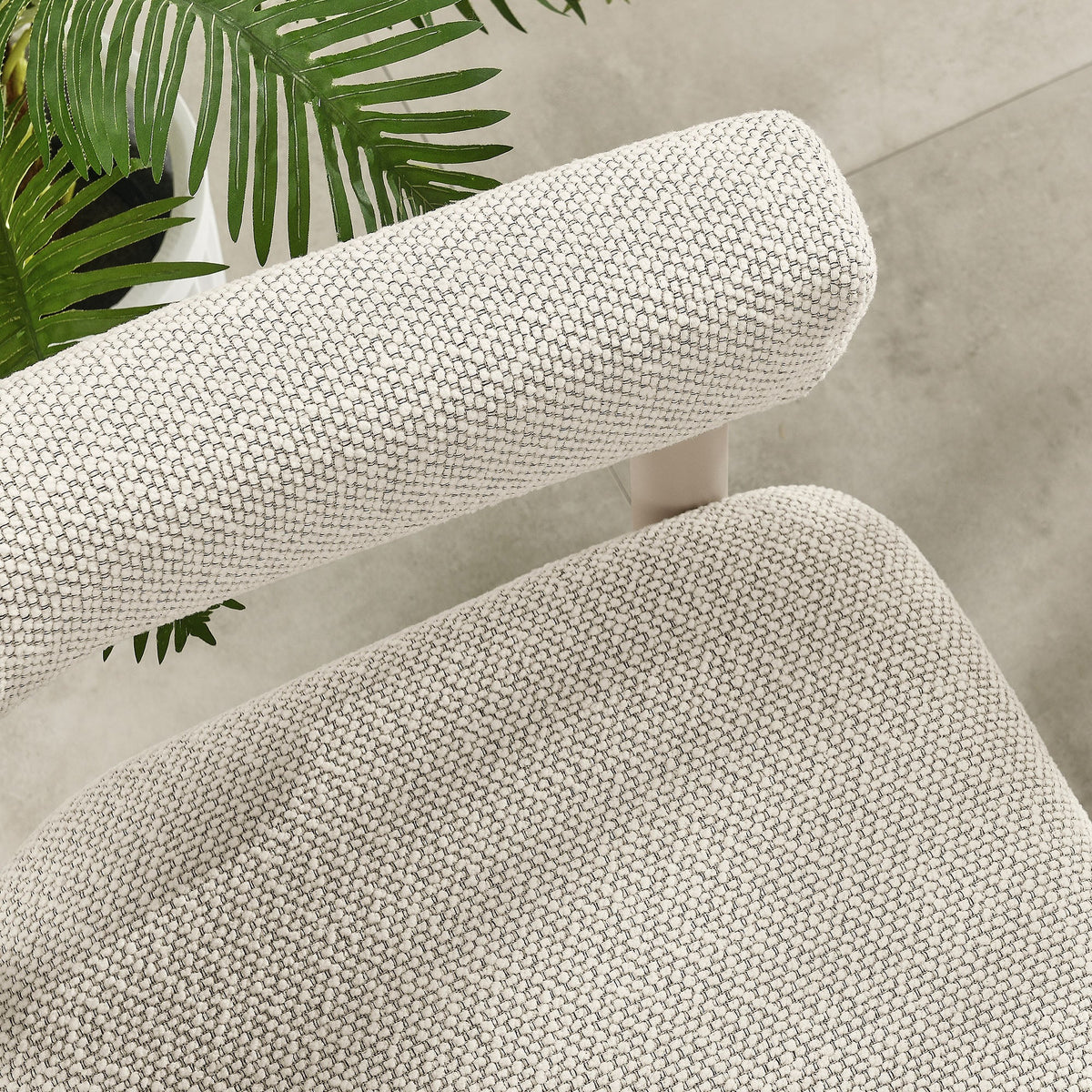 Beige woven outdoor cushion fabric close-up with green tropical leaves on Tampa Home & Garden Store