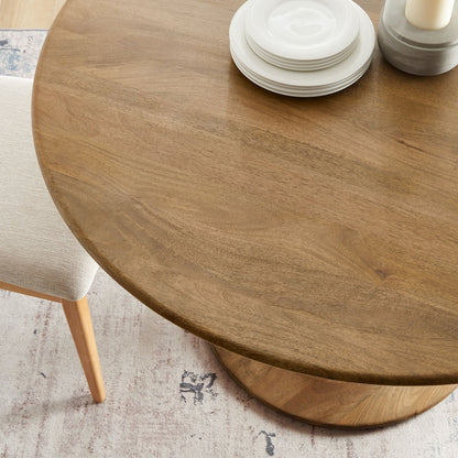 Lippa 48in round solid wood dining table with white plate stack and candle centerpiece on Tampa Home & Garden Store
