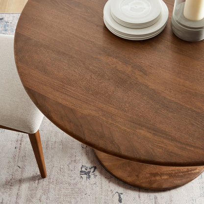 Lippa 48in round solid wood dining table with white plates and candle holder on Tampa Home & Garden Store