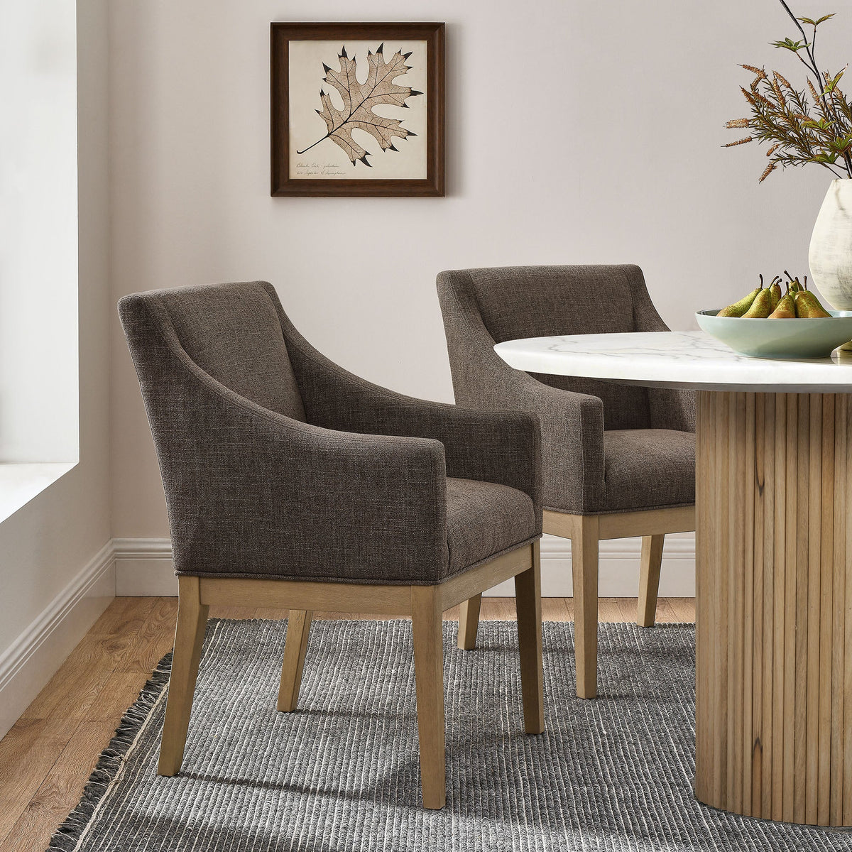 Alton Fabric Upholstered Dining Armchairs, charcoal gray fabric, light wood legs around a marble dining table on Tampa Home & Garden Store