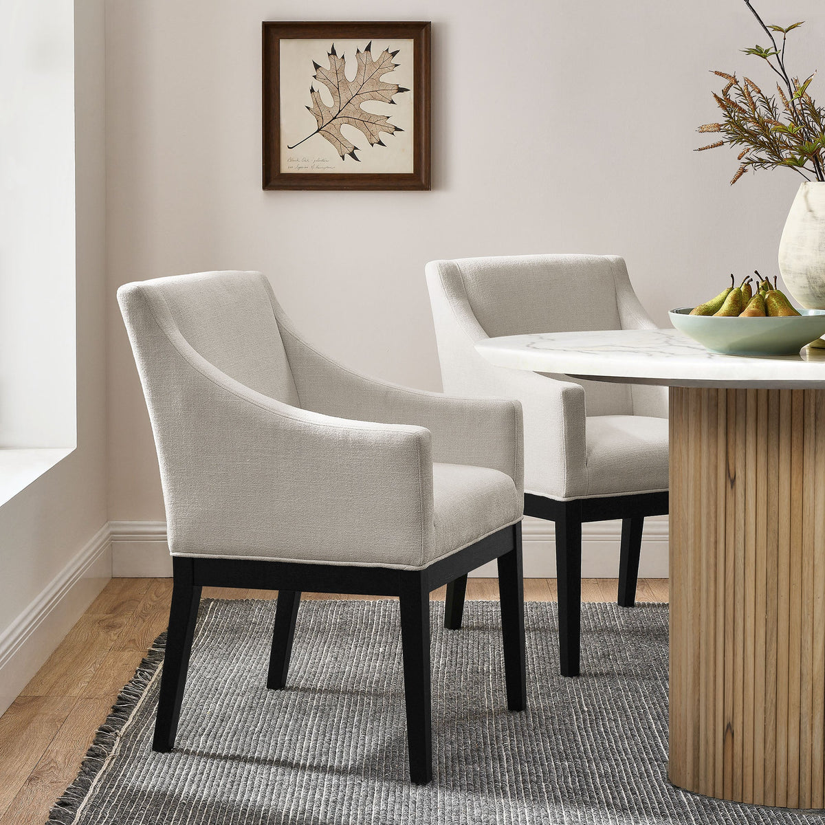 3 Alton Fabric Upholstered Dining Armchairs in light gray with black legs around a marble table on Tampa Home & Garden Store