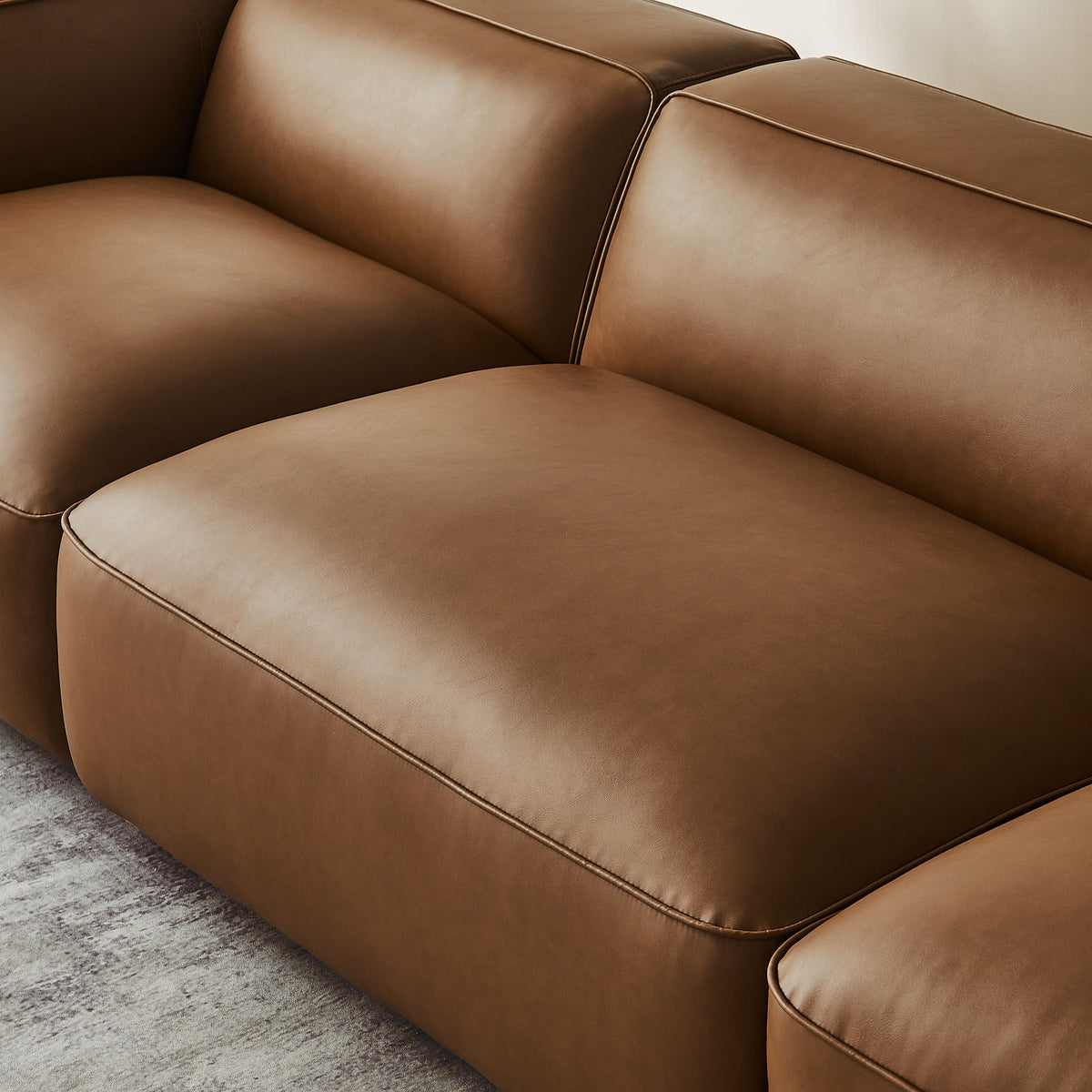 Auren 3-Piece Upholstered Vegan Leather Sofa closeup of tan cushions with seam piping on Tampa Home & Garden Store