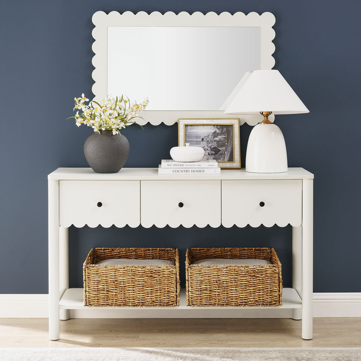 Emmeline 3-Drawer Scalloped Console Table in white with vase, lamp, and books on navy backdrop on Tampa Home & Garden Store