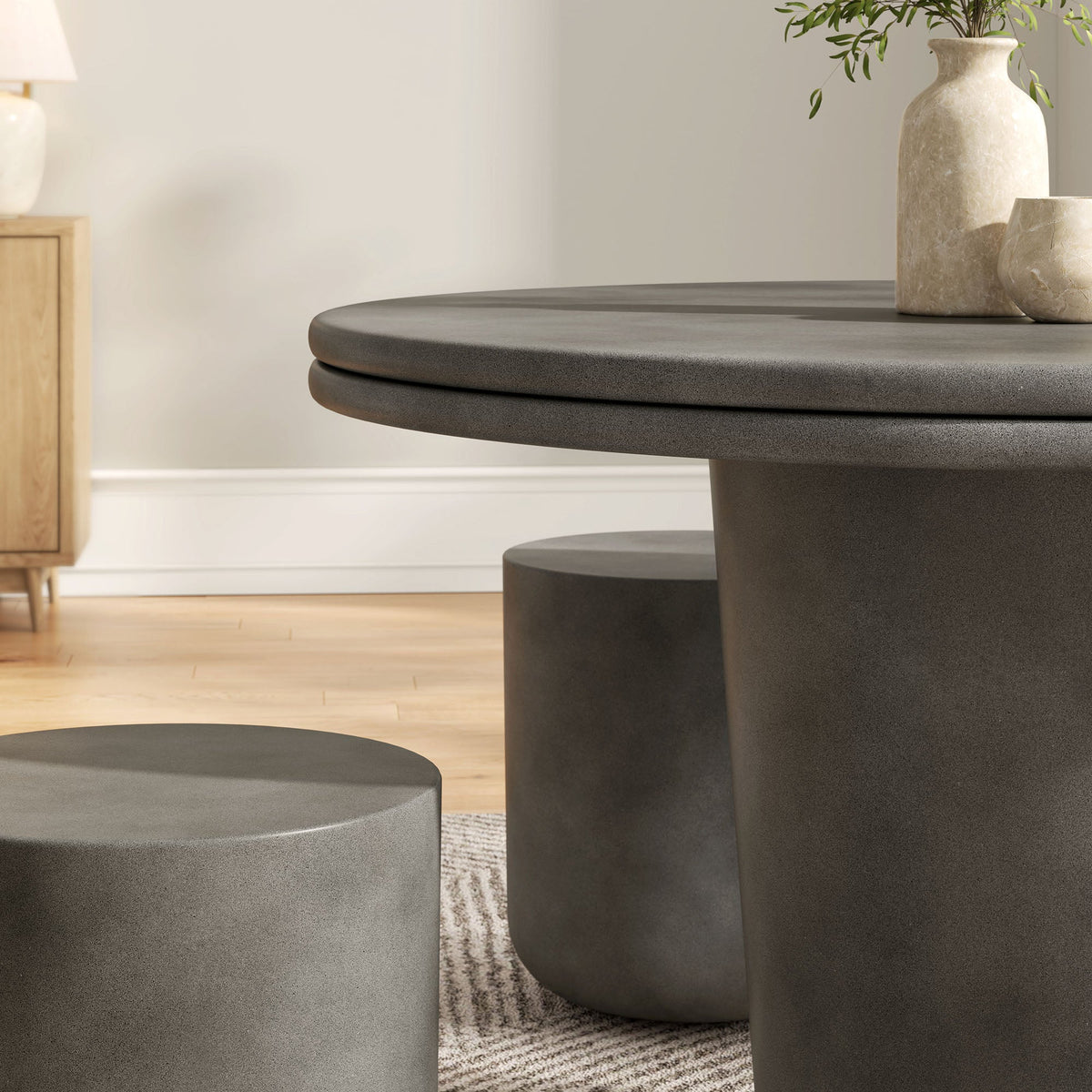 Modway Brion concrete round dining table set in dark gray with beige stone vases in a home on Tampa Home & Garden Store