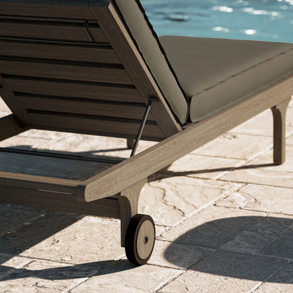 Saratoga teak chaise lounge chair with gray cushion on a wooden frame with wheels on Tampa Home & Garden Store
