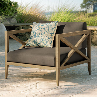 Northlake outdoor teak armchair with dark brown cushions and blue leaf-pattern pillow on Tampa Home & Garden Store