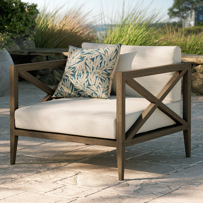 Northlake outdoor patio teak armchair with beige cushion and blue botanical pillow on Tampa Home & Garden Store