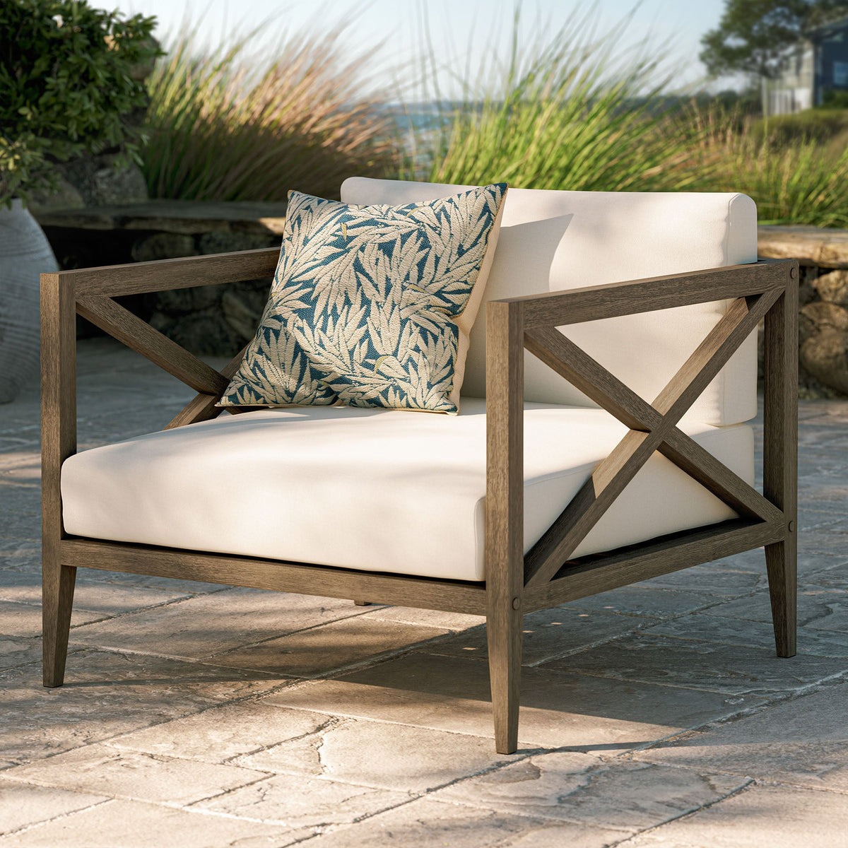 Northlake teak armchair by Modway with beige cushion and blue botanical pillow on a wood frame on Tampa Home & Garden Store