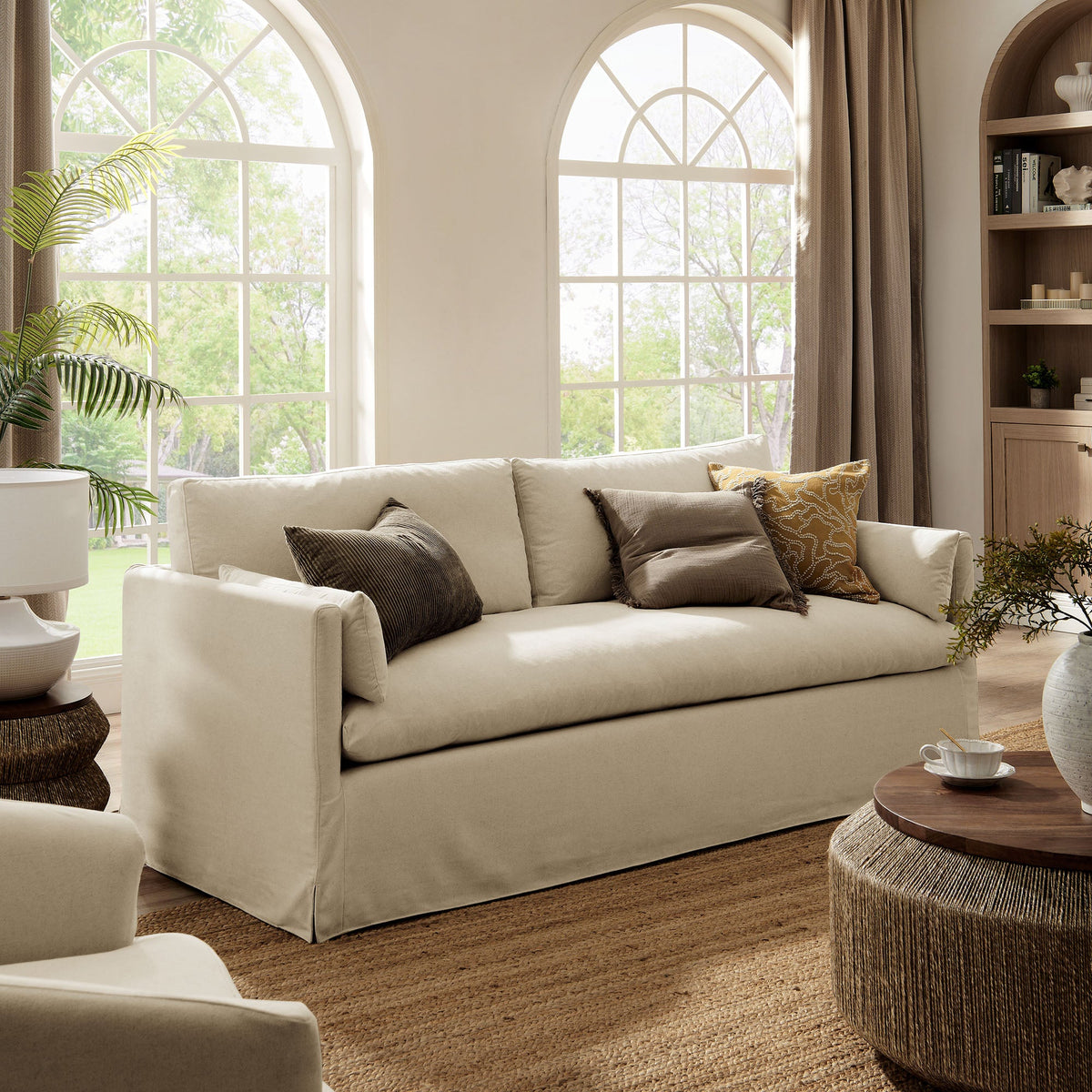 Wellfleet 85-in slipcovered sofa by Modway cream upholstery with brown pillows in a living room on Tampa Home & Garden Store