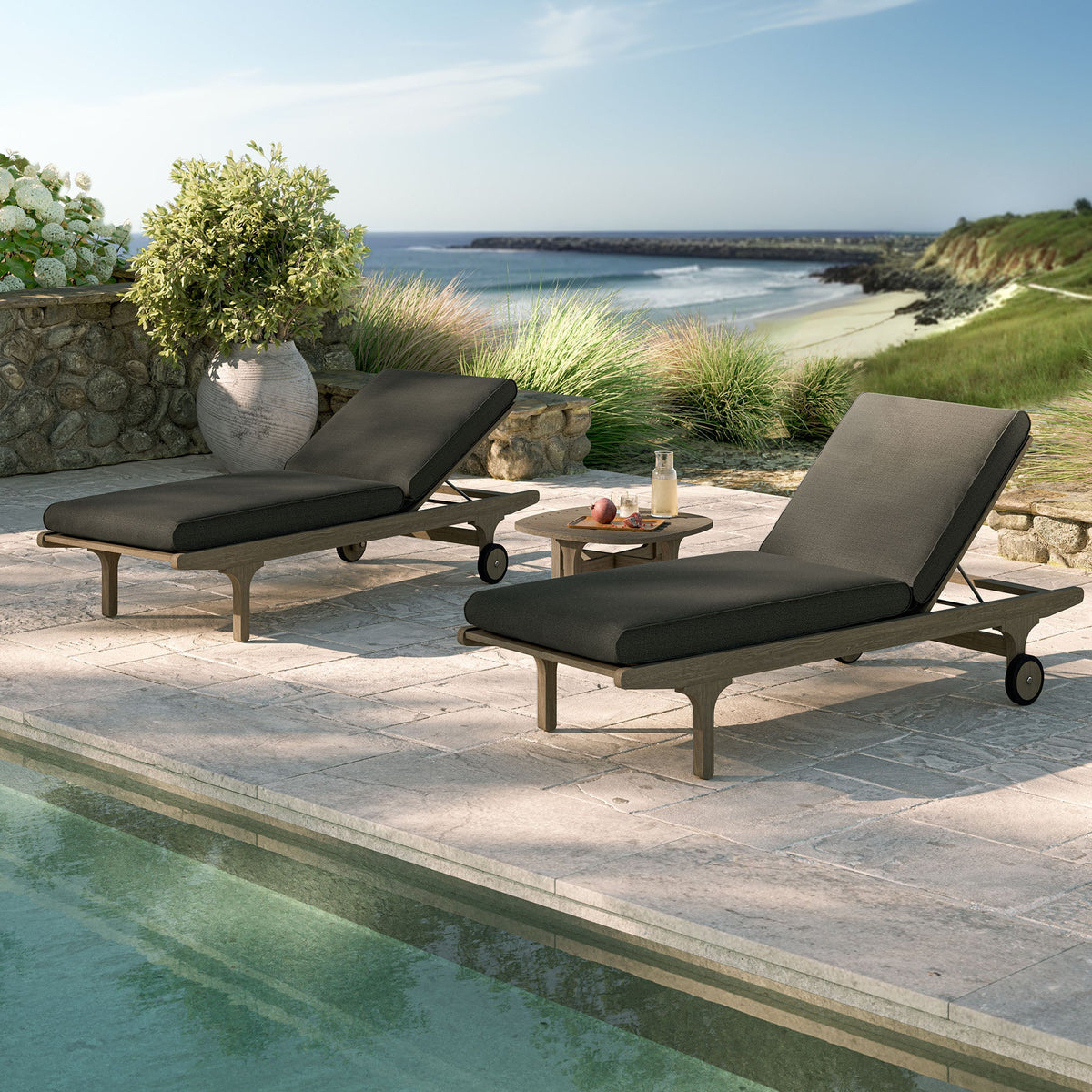 Saratoga teak 3-piece chaise lounge set with black cushions and side table on coastal deck on Tampa Home & Garden Store