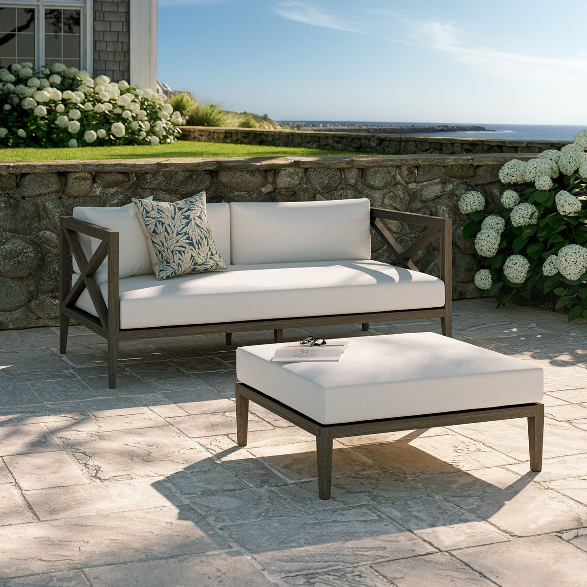 Northlake outdoor teak loveseat and ottoman set with white cushions for a coastal patio on Tampa Home & Garden Store
