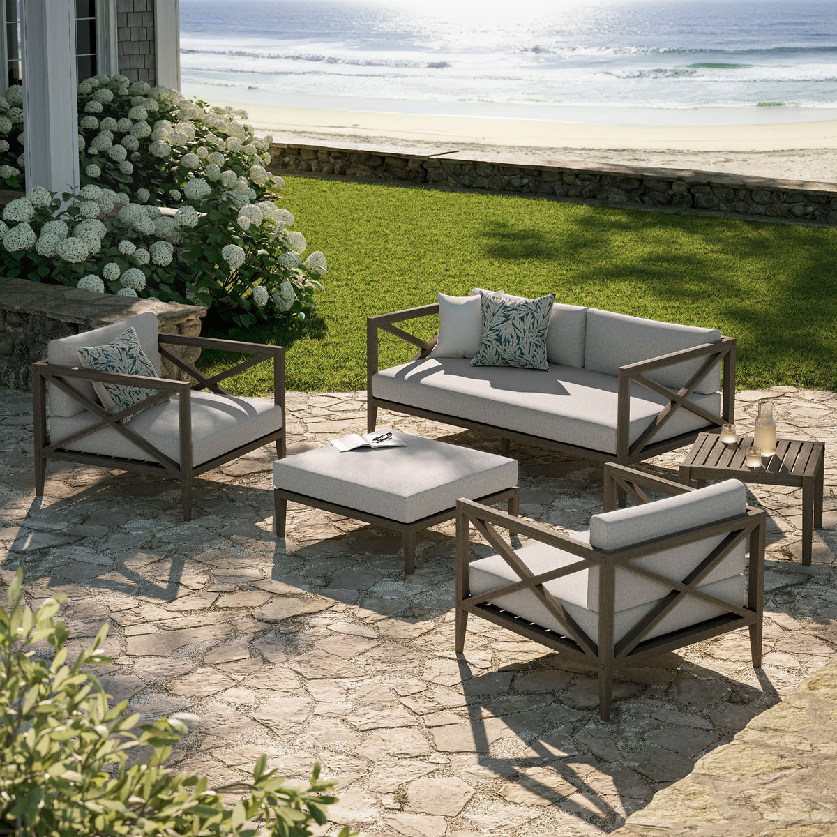 Northlake 5-piece teak outdoor sofa set with light gray cushions on seaside patio on Tampa Home & Garden Store
