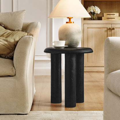 Mavina Mango Wood Side Table with black cylindrical legs and round top in a living room on Tampa Home & Garden Store