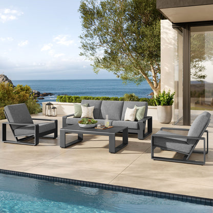 Lirienne 4-piece outdoor aluminum furniture set with gray cushions on a poolside patio on Tampa Home & Garden Store
