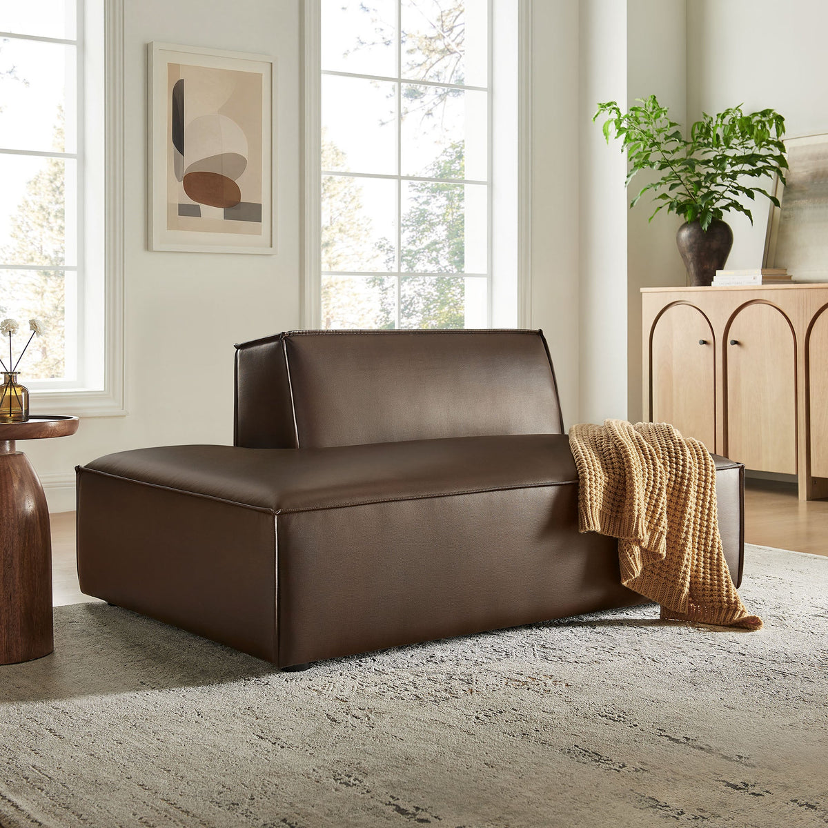 Restore vegan leather left-facing armless modular chaise in dark brown in a living room on Tampa Home & Garden Store