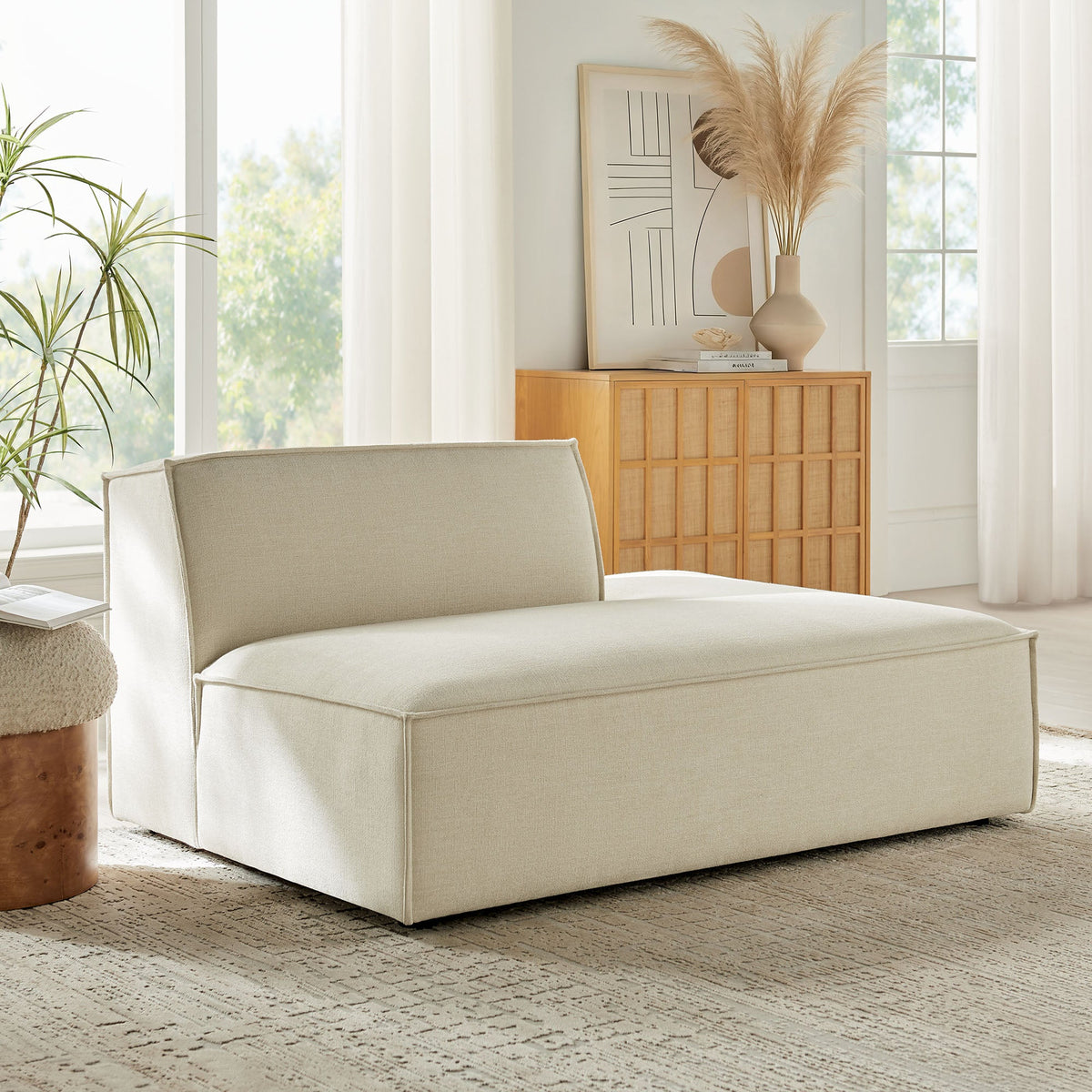 Right-facing armless chaise in beige performance fabric in room with pampas grass on Tampa Home & Garden Store