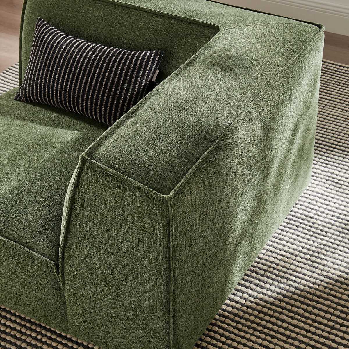 Modular corner chair in green Restore Performance fabric with striped lumbar pillow on Tampa Home & Garden Store