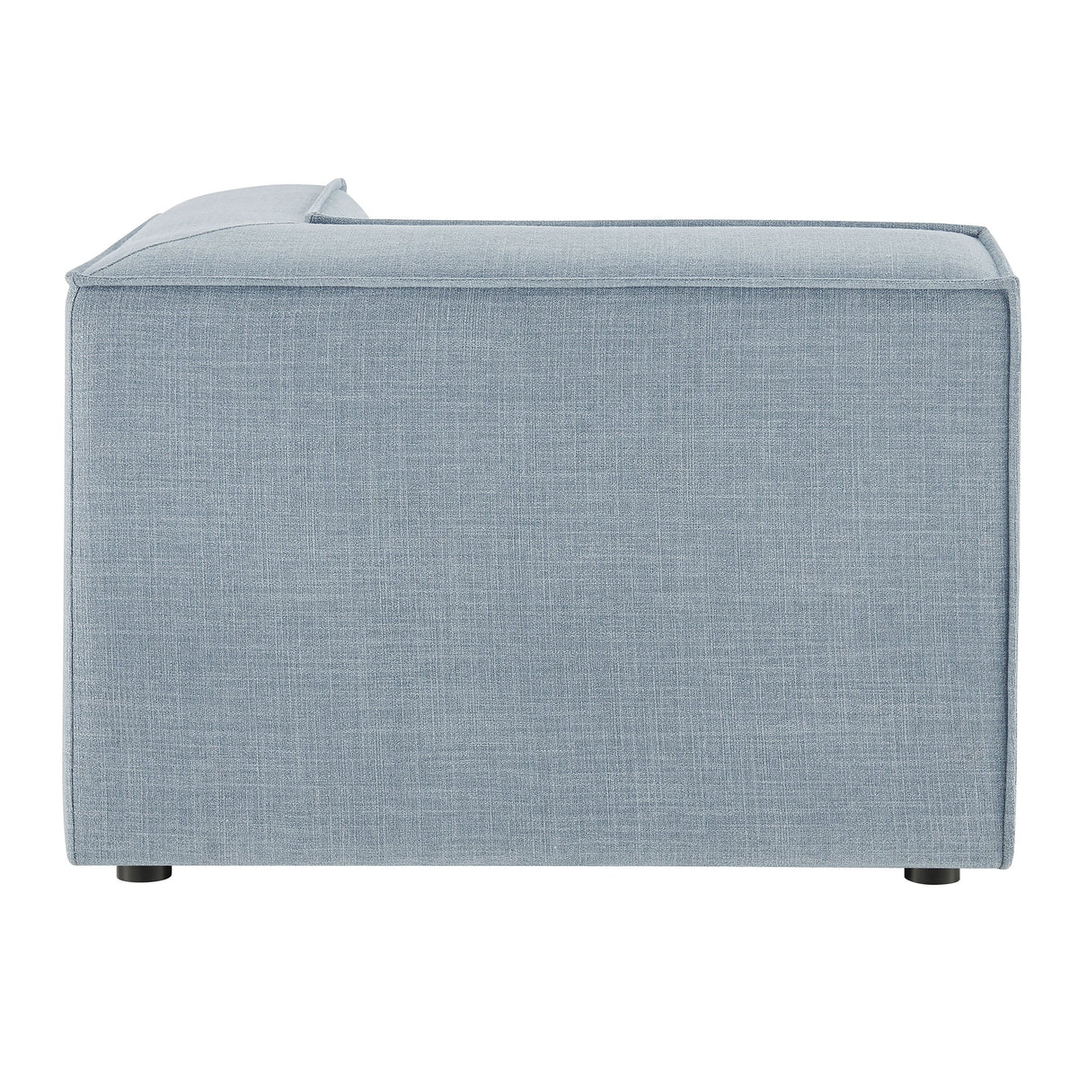 Modular corner chair in light blue performance fabric with visible seams and black feet on Tampa Home & Garden Store