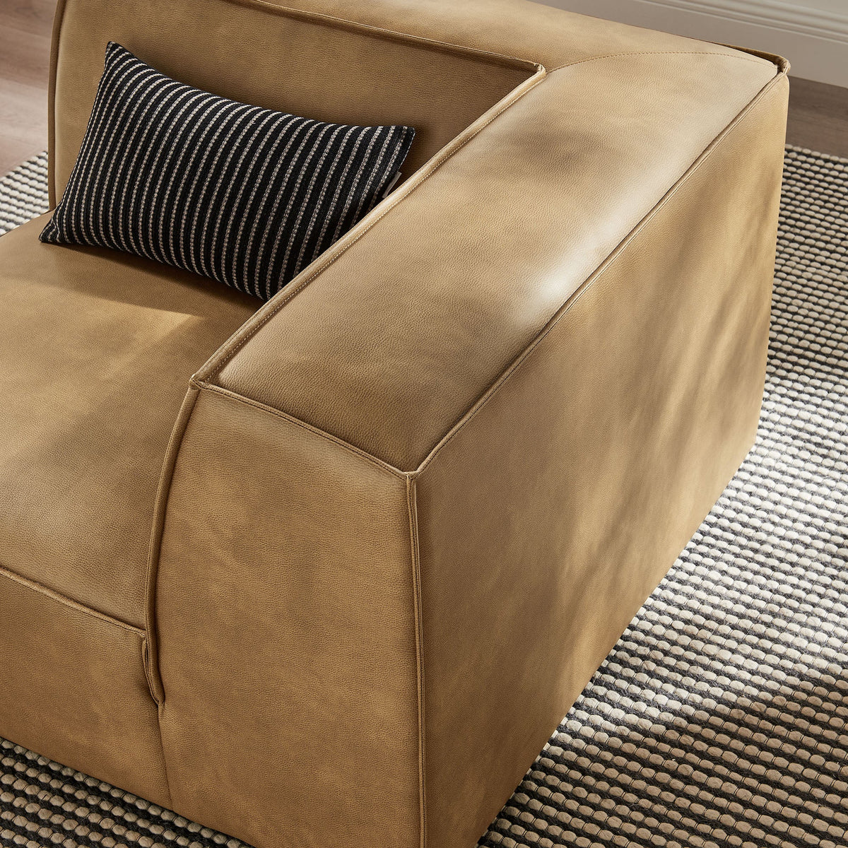 Restore vegan leather modular corner chair in tan with black striped lumbar pillow on Tampa Home & Garden Store