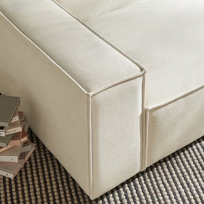 Left-facing modular lounge chair in beige performance fabric with piped seams on Tampa Home & Garden Store