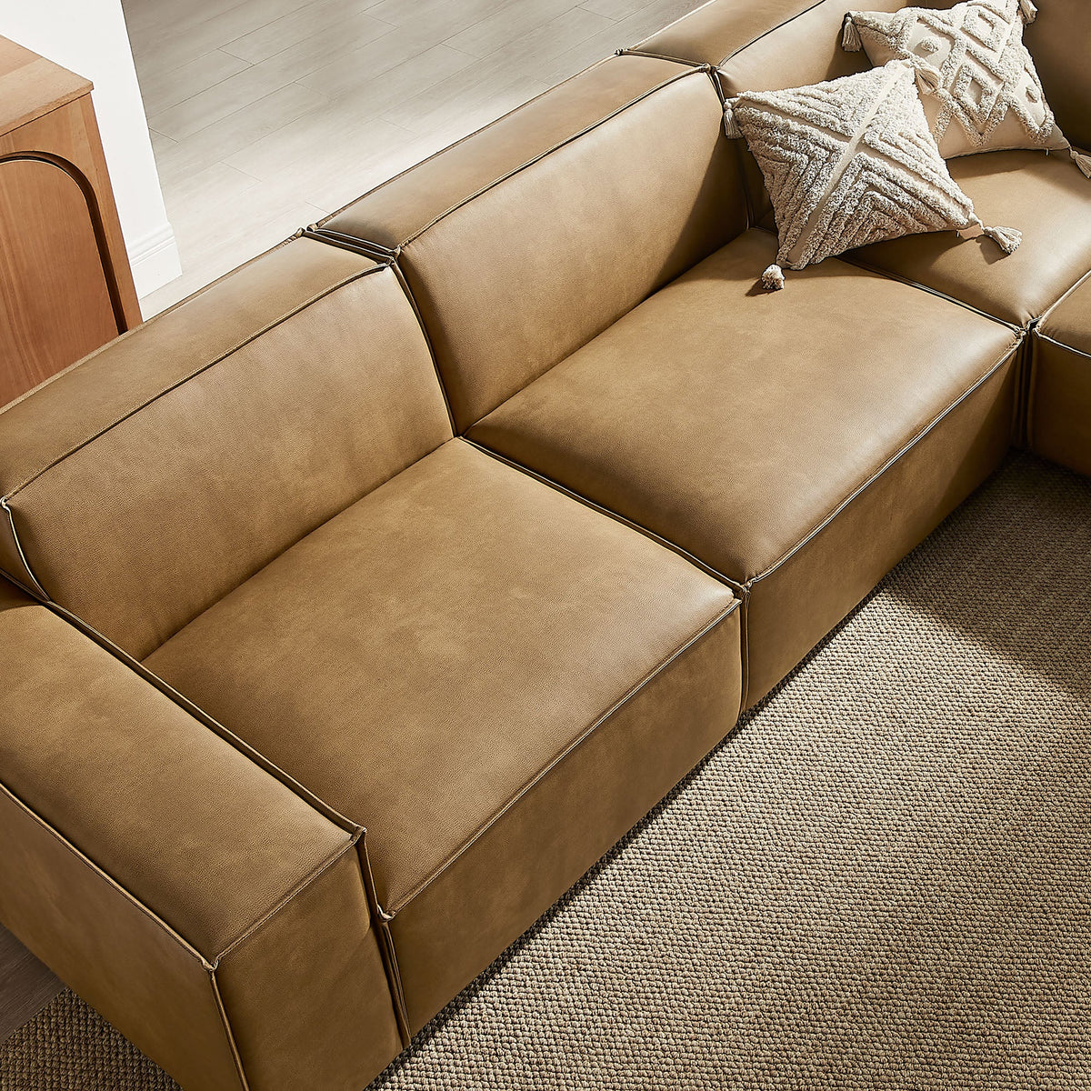 Restore 5pc vegan leather modular L-shaped sofa in tan with piping and tassel pillows on Tampa Home & Garden Store