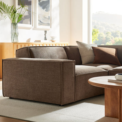 Modular L-shaped sectional sofa in mocha performance fabric with plush cushions in a sunlit living room on Tampa Home & Garden Store
