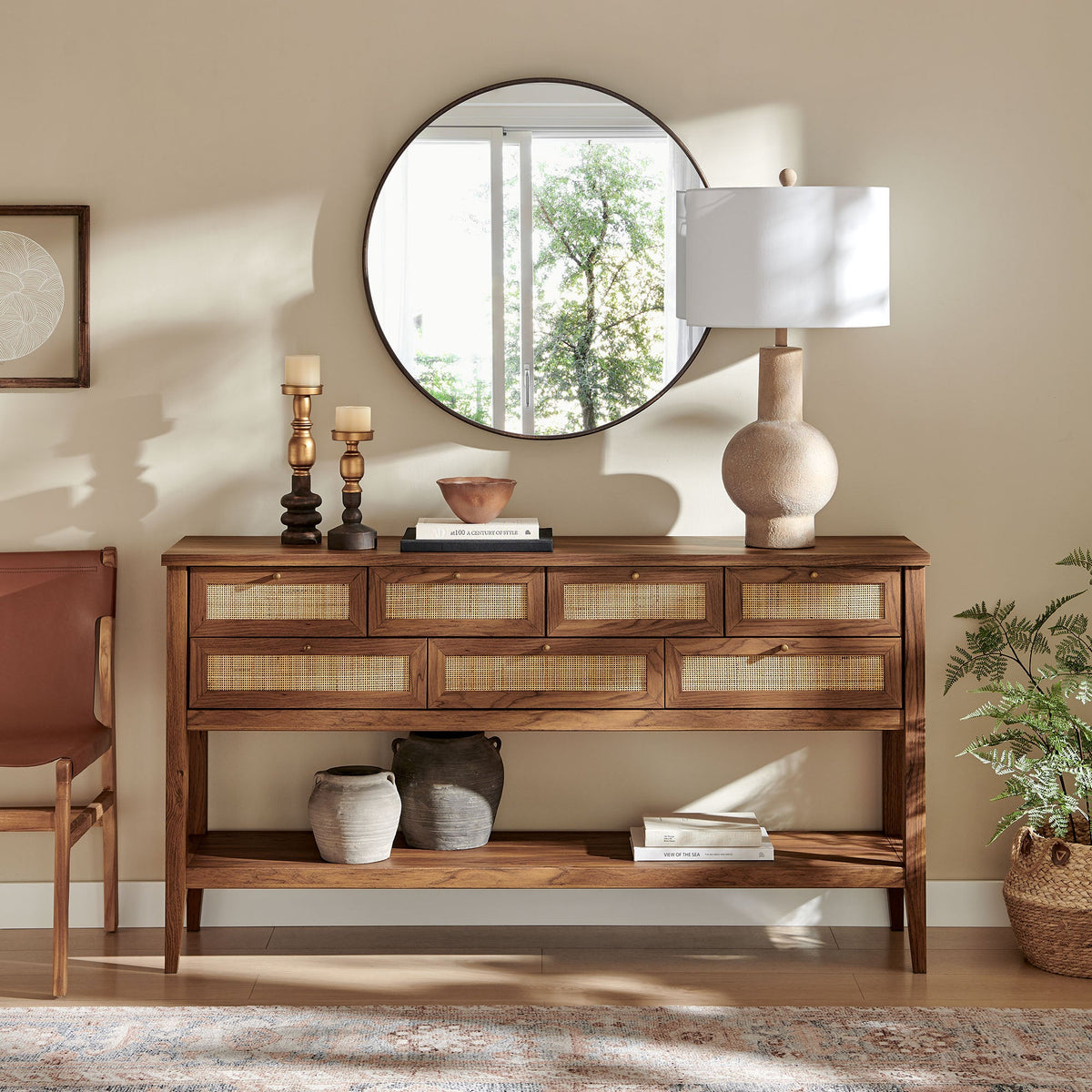Soma 62 Inch Rattan Console Table with caned drawers in warm wood, round mirror above on Tampa Home & Garden Store