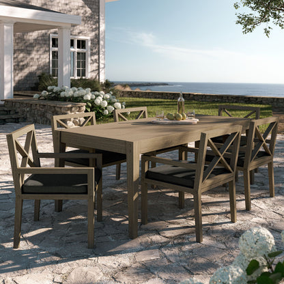 Northlake 7-piece teak outdoor dining set with cross-back chairs and cushions on sunlit patio on Tampa Home & Garden Store