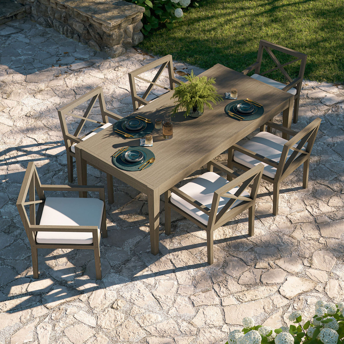 Northlake 7-Piece Outdoor Teak Wood Dining Set with cushioned white seats and X-back chairs on Tampa Home & Garden Store
