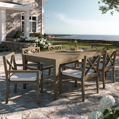 Northlake 7-piece outdoor teak dining set with white cushions on seaside patio on Tampa Home & Garden Store