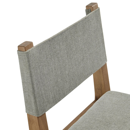 Calder fabric upholstered wood armless dining chair in gray with exposed wood legs on Tampa Home & Garden Store