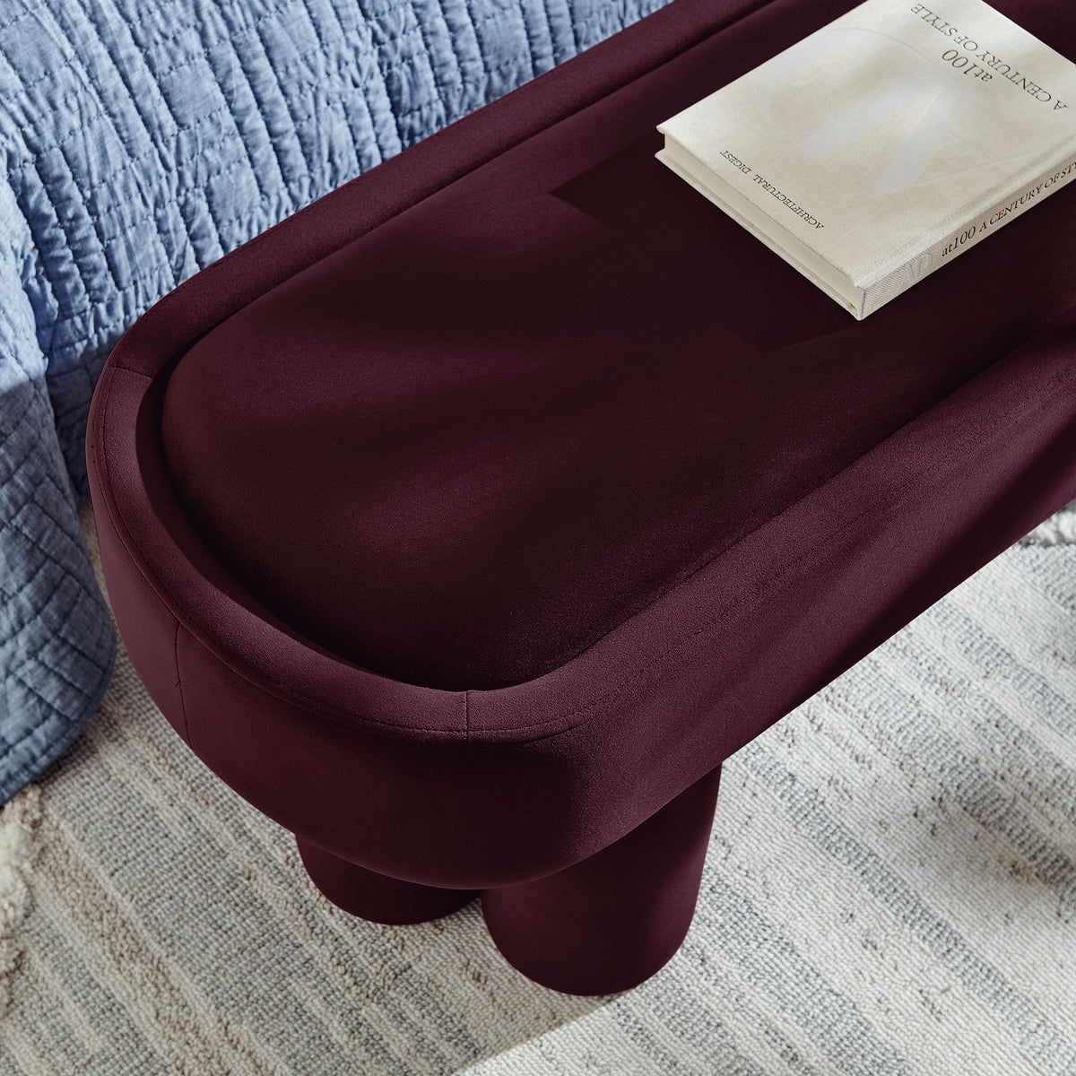 Mossi Oval Performance Velvet Accent Bench burgundy with beige book on blue quilt backdrop on Tampa Home & Garden Store