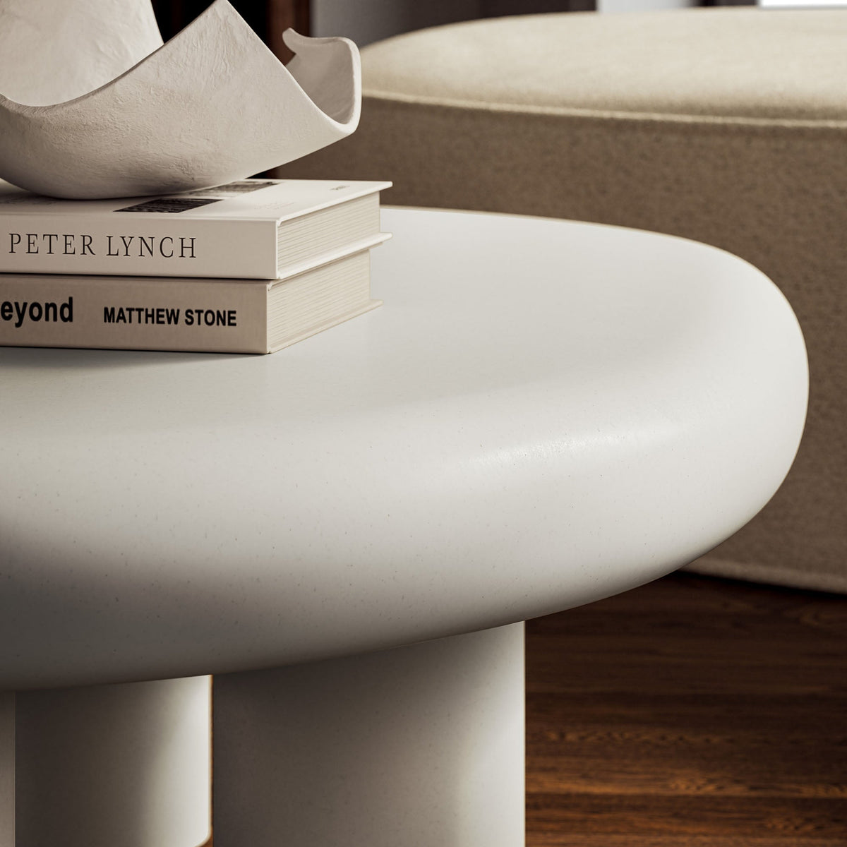 Elowen outdoor patio coffee table by Modway; white round top with a stack of Peter Lynch books on Tampa Home & Garden Store
