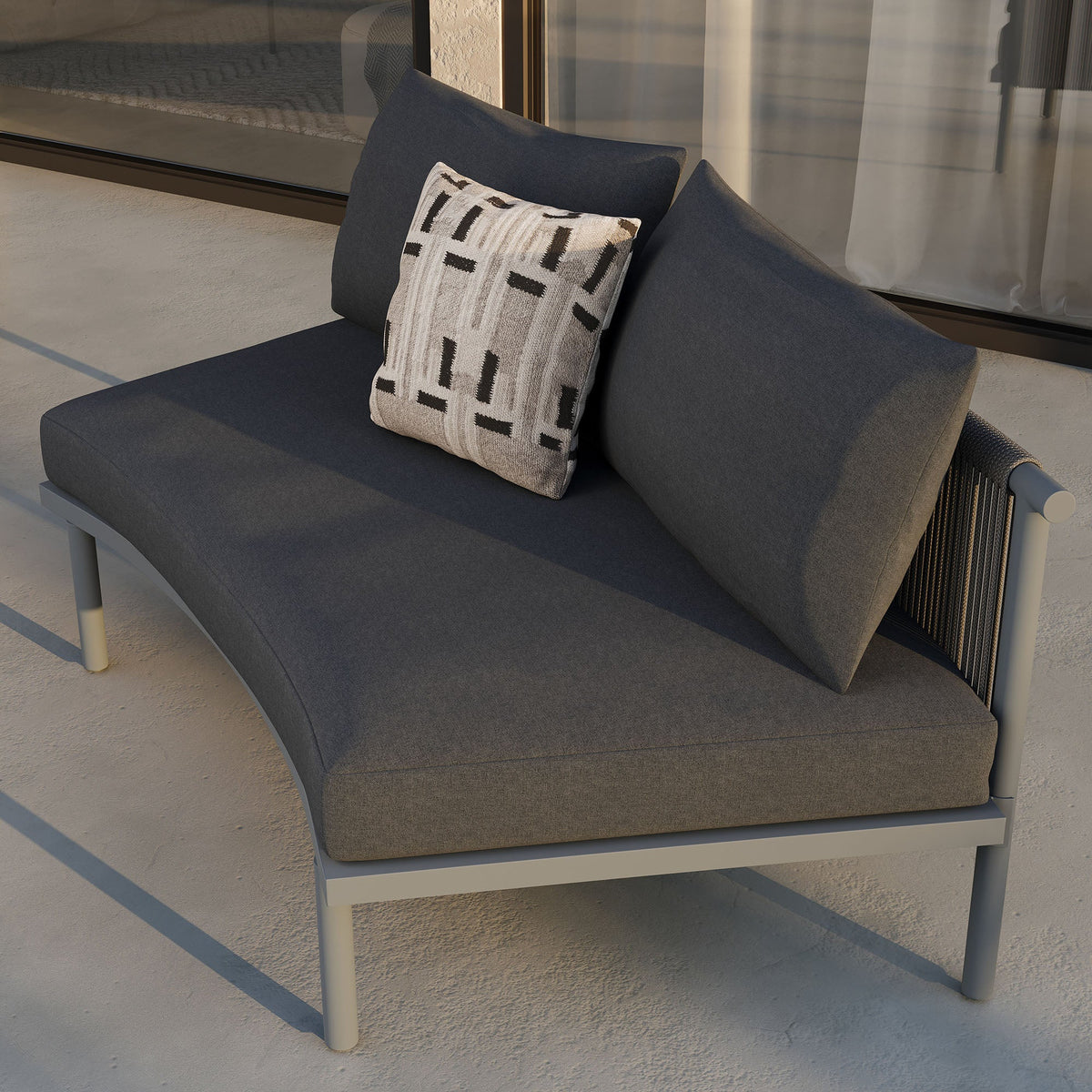 Porta armless outdoor modular sofa in dark gray fabric on aluminum frame with geometric pillow on Tampa Home & Garden Store