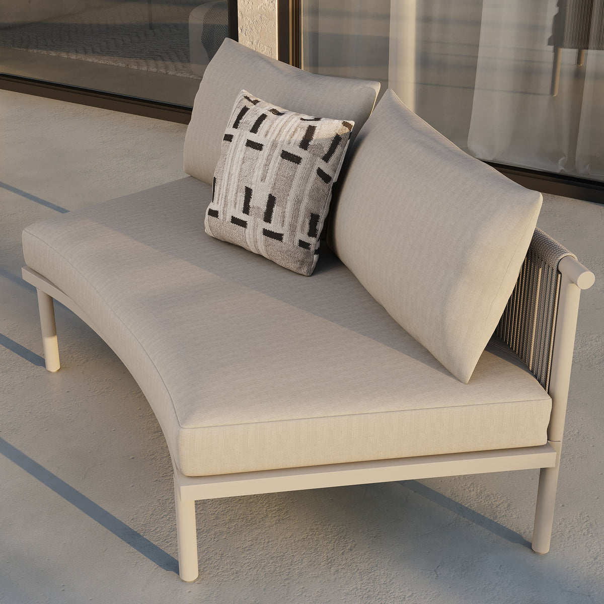 Armless outdoor sofa module in beige fabric with aluminum frame and geometric pillow on a patio on Tampa Home & Garden Store