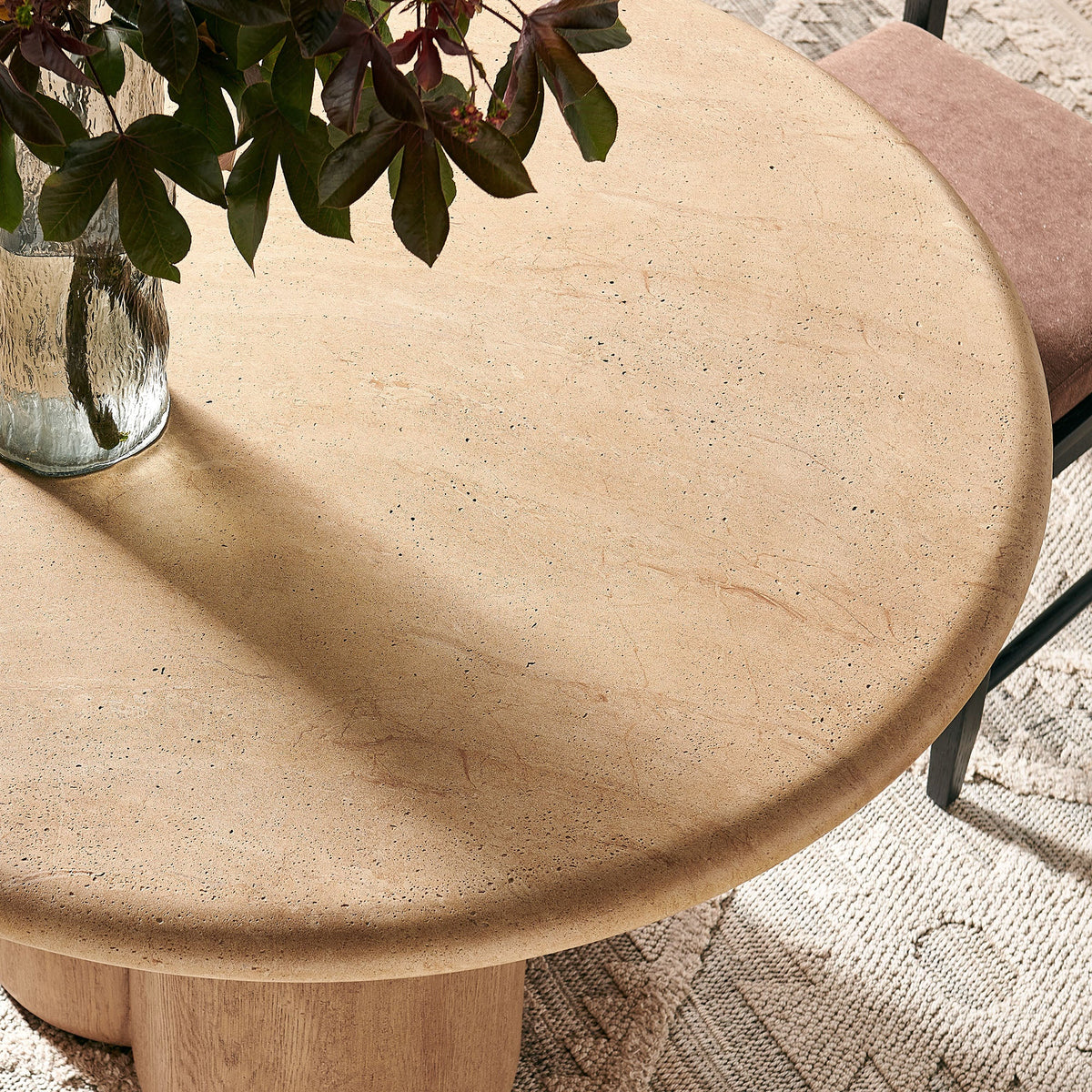 Tori 48-inch round dining table with speckled beige stone top and wood pedestal base on Tampa Home & Garden Store