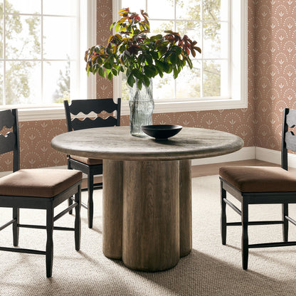 Tori 48-inch round dining table with wood top and dark base, black chairs in bright dining room on Tampa Home & Garden Store