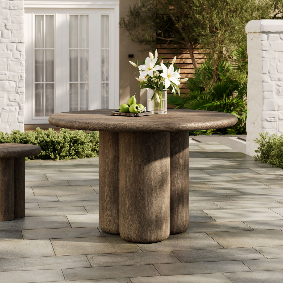 Tori 48 inch round indoor/outdoor dining table in dark wood with pedestal base lilies and apples on top on Tampa Home & Garden Store