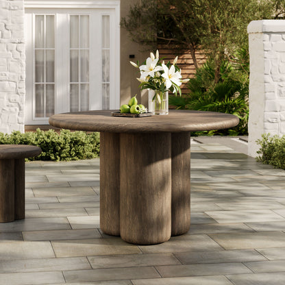 Tori 48 inch round indoor/outdoor dining table in dark wood with pedestal base lilies and apples on top on Tampa Home & Garden Store