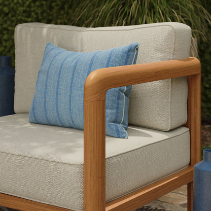 Kona outdoor teak right-arm facing modular armchair with beige woven cushions and a blue pillow on Tampa Home & Garden Store