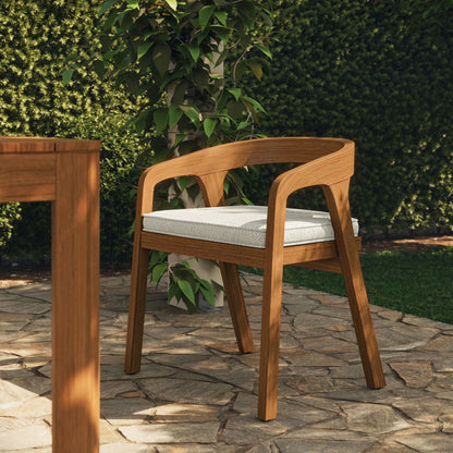 Kona outdoor teak wood barrel dining chair with light gray cushion in garden patio on Tampa Home & Garden Store