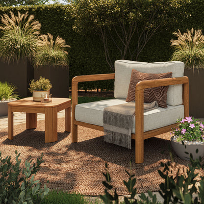 Teak Kona outdoor sofa with beige cushions beside a teak side table on a woven rug on Tampa Home & Garden Store